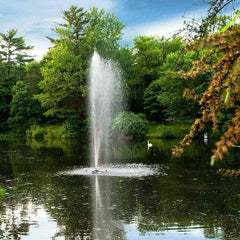 Scott 1/2HP Pond Fountain Gusher Pattern by Scott Aerator Operating in a Pond with Trees at the Back 13513