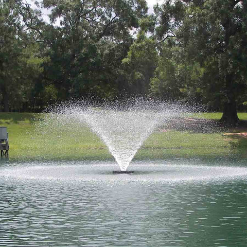 Kasco 1/2HP Aerating Fountain 2400VFX  Operating in a Pond Surrounded by Trees